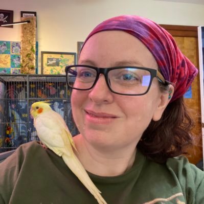 A photo of Coral and a white cockatiel.
