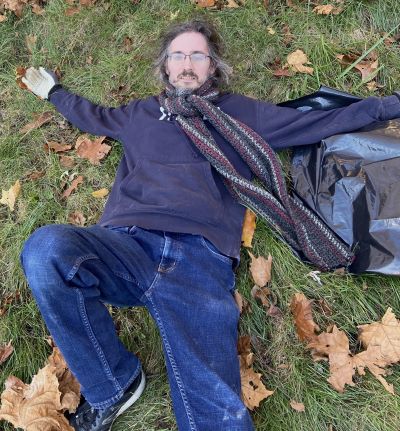 A photo of Dale, sprawled amongst grass and leaves.